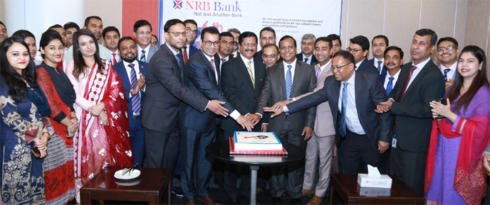 Md Mehmood Hussain, Managing Director of NRB Bank Ltd, celebrating the Bank's 6th Anniversary by cutting cake at its Head Office in the city recently. Md Khurshed Alam, Deputy Managing Director and members of senior management team were present.