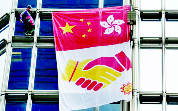 French urban climber Alain Robert climbs the Cheung Kong Center building in Hong Kong on Friday.