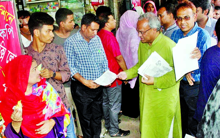 BNP Joint Secretary General Ruhul Kabir Rizvi distributing leaflets on dengue at Bangabandhu Sheikh Mujib Medical University campus yesterday.