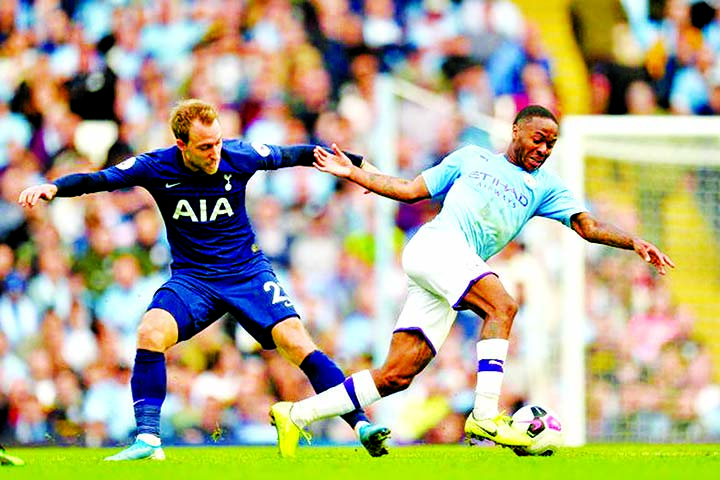 Manchester City's Raheem Sterling (right) in action against Tottenham Hotspur's Christian Eriksen during the English Premier League soccer match between Manchester City and Tottenham Hotspur at the Etihad Stadium in Manchester, Britain on Saturday.
