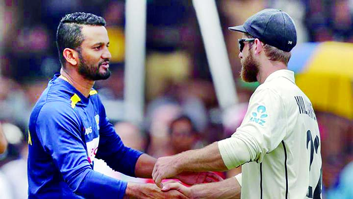 New Zealand's captain Kane Williamson congratulates his Sri Lankan counterpart Dimuth Karunaratne (left) during the fifth and final day of the opening Test at Galle in Sri Lanka on Sunday.