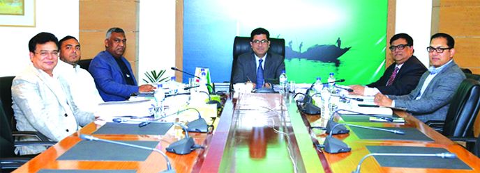Barrister Sheikh Fazle Noor Taposh MP, EC Chairman of Modhumoti Bank Limited, presiding over its 86th meeting at the bank's head office in the city recently. Mohammad Ismail Hossain, Managing Director of Sharmin Group, Salahuddin Alamgir, Chairman of Lab