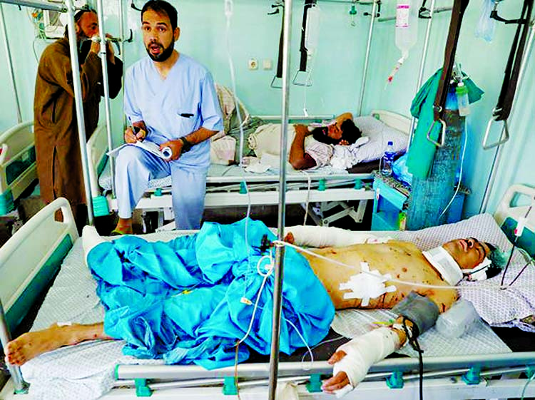 A man rests on a bed while receiving treatment in the hospital after sustaining injuries from a blast at a wedding hall in Kabul on Sunday. Internet photo