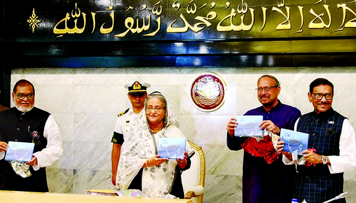 Prime Minister Sheikh Hasina along with other distinguished persons holds the copies of a book titled 'Swapna Panshi' written by Science and Technology Minister Yafesh Osman at its cover unwrapping ceremony at the beginning of cabinet meeting on Monday.