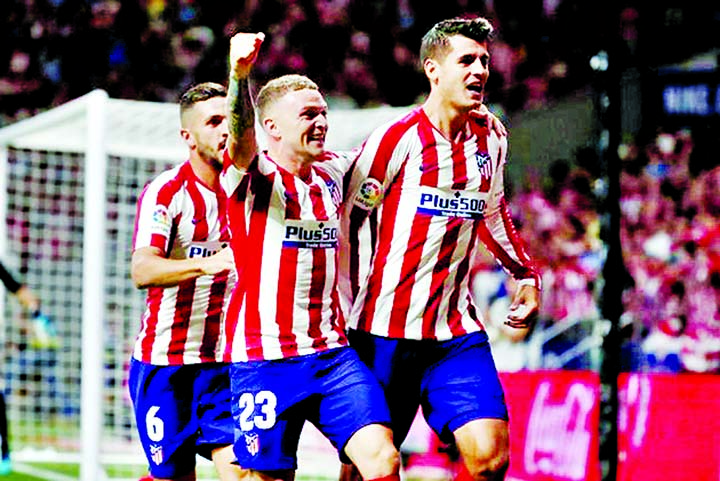 Alvaro Morata (right) celebrates with teammates after scoring a goal during the La Liga game between Atletico Madrid and Getafe on Sunday.