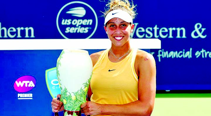 Madison Keys, of the United States, holds the Rookwood Cup after defeating Svetlana Kuznetsova, of Russia, in the women's final match during the Western & Southern Open tennis tournament.