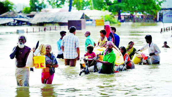 Flood-affected residents of a low lying area on the bank of the River Ganges move with their belongings to the drier ground as the water level of the Ganges and Yamuna rivers rise rapidly after heavy rainfall in the region, in Prayagraj (Allahabad).