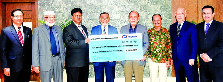 Md. Nurun Newaz Salim, Chairman of NCC Bank Limited, handing over a cheque of Tk. 20,30,000 to Abdus Sattar, President and Mir Hossain Miru, General Secretary of the Executive Council of National Heart Foundation Hospital and Research Institute, Feni at t