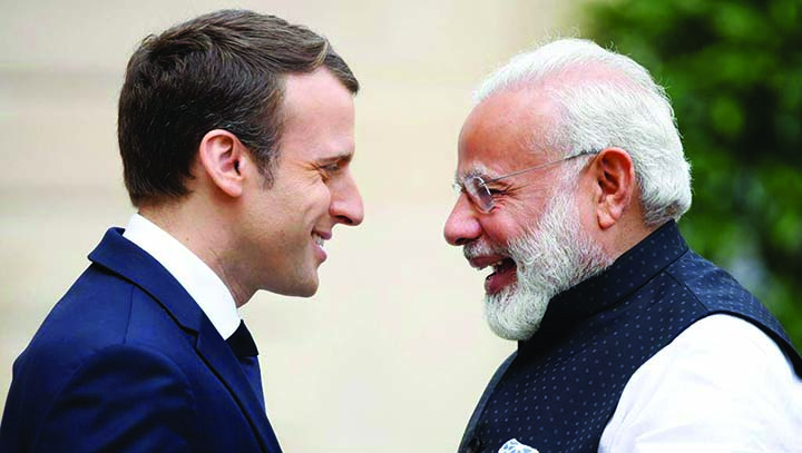 French President Emmanuel Macron greets visiting Indian Prime Minister Narendra Modi at the ElysÃ©e Palace in Paris in this AP file photo
