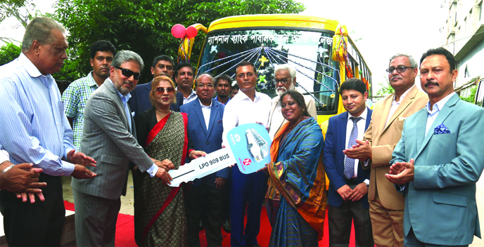 Parveen Haque Sikder, Director and EC Chairperson of National Bank Limited, handing over keys of four School Buses to authority of the National Bank Public School and College on Thursday. Managing Director Choudhury Moshtaq Ahmed, members of the Managemen