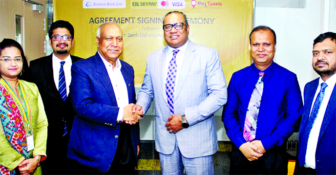 M Khorshed Anowar, Head of Retail and SME Banking of Eastern Bank Limited and Md Monowar Rahman, CEO of Buy Tickets, exchanging an agreement signing document at the bank's head office in the city recently. Under the deal, customers of Buy Tickets will no