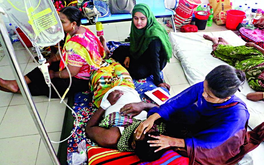 Dengue patients lying on the floor in the Sir Salimullah Medical College Hospital in Dhaka as the public hospital lacks adequate beds for extending proper care to dengue patients. This photo was taken on Friday.