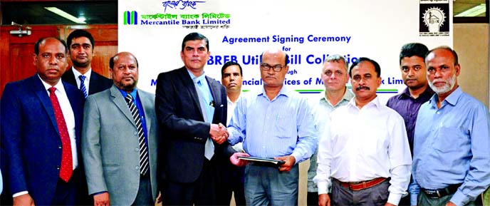 Adil Raihan, DMD of Mercantile Bank Limited and Md. Asafuddaula, Secretary of Bangladesh Rural Electrification Board (BREB), shaking hands after signing an agreement regarding collection of monthly bill payment of BREB through the bank's mobile financial