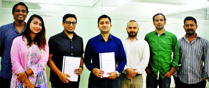 Shahrim Sanjeed, Director of Elson Foods (BD) Limited and Ehsan Kabir, CEO of Green Ink, along with senior executives from both sides, pose for a photograph after signing a MoU at Green Ink head office in the city on Sunday.