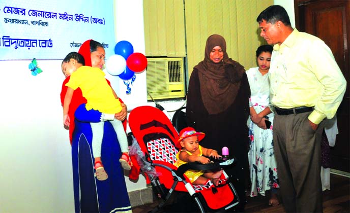 Major General (retd.) Moin Uddin, Chairman of Bangladesh Rural Electrification Board (BREB), exchanging views with parents after inaugurating the 'Day Care Center' at its headquarters in the city on Sunday while Abul Kalam Shamsuuddin, Member (Admin) an