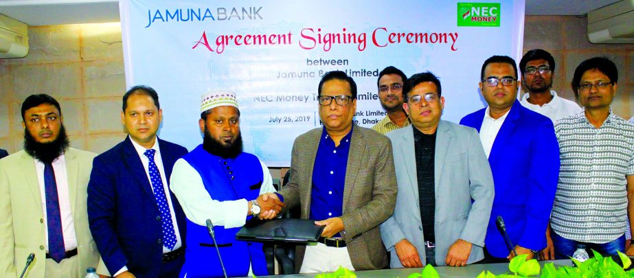Shafiqul Alam, CEO of Jamuna Bank Limited and Ikram Farazy, Chairman of NEC Money Transfer Limited, exchanging an agreement signing document at the bank's head office in the city recently. Under the deal, beneficiaries will be able to receive their rem