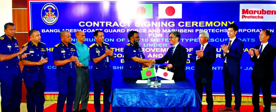 M Nurul Islam Sharif of Bangladesh Navy and Ken Sugimoto on behalf of Marubeni Protechs Corporation of Japan, exchanging a contract signing document at Bangladesh Coast Guard Headquarters in the city on Tuesday. Under the deal, JICA will donate some 20 re