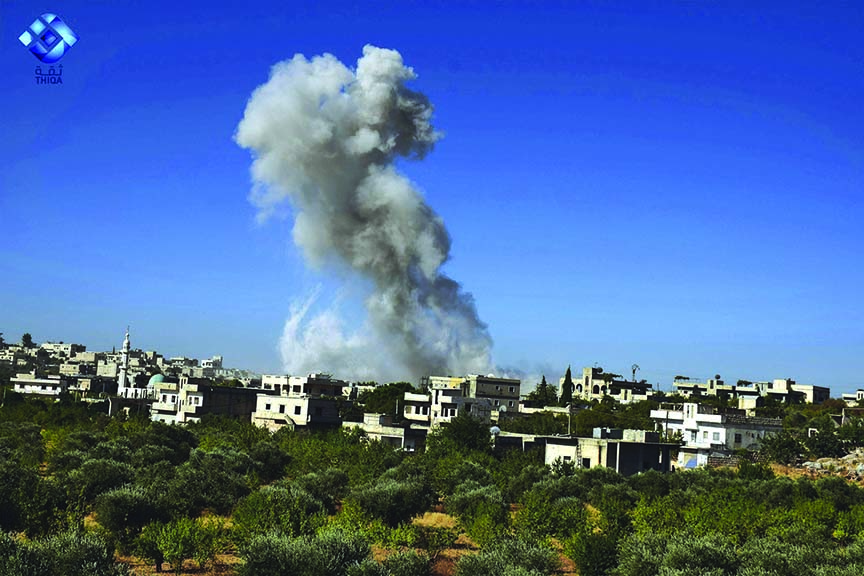 Photo shows smoke rising after airstrikes hit the town of Ihsem, in Idlib province, Syria, on Monday.