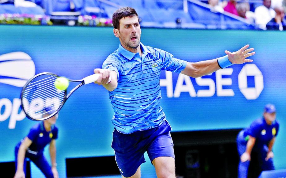 Novak Djokovic of Serbia, returns a shot to Roberto Carballes Baena of Spain, during the first round of the US Open tennis tournament in New York on Monday.