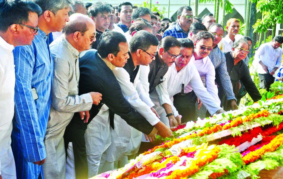 Awami League General Secretary and Road Transport and Bridges Minister Obaidul Quader along with party colleagues placing wreaths on the Mazar of National Poet Kazi Nazrul Islam at Dhaka University on Tuesday marking the 43rd death anniversary of the poet