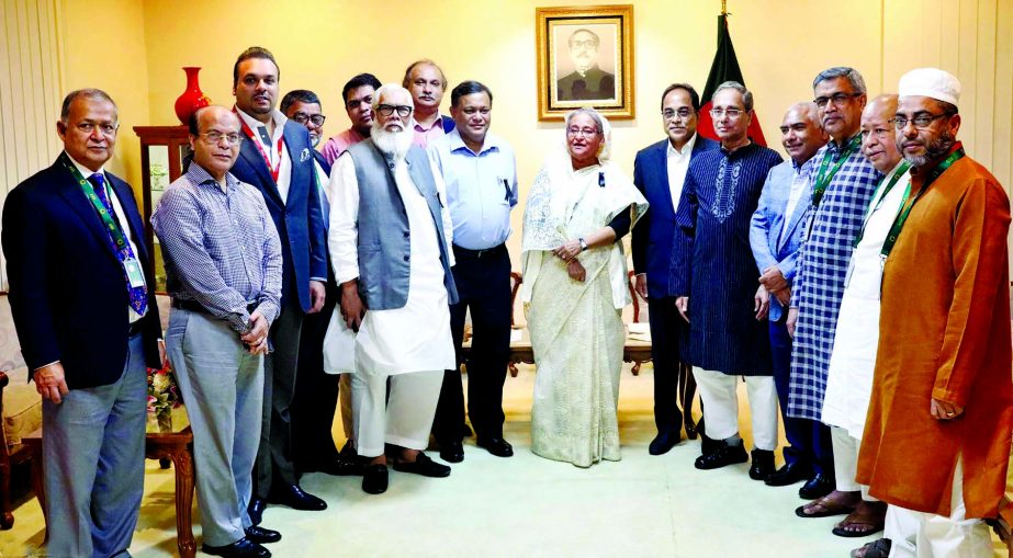 Prime Minister Sheikh Hasina poses for a photo session with the newly elected members of the Association of Television Channel Owners (ATCO) when they called on her at her office on Wednesday. BSS photo