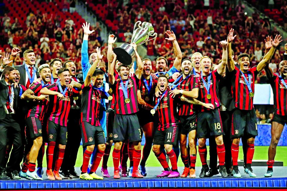Atlanta United players celebrate with the trophy after defeating Minnesota United 2-1 in the U.S. Open Cup soccer final in Atlanta on Tuesday.