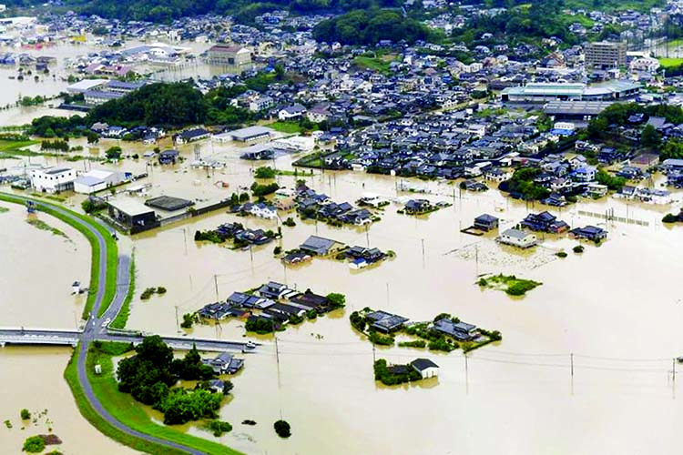 An aerial view shows submerged houses and facilities at a flooded area in Takeo, Saga prefecture, southern Japan on Wednesday at least two were killed and 850,000 evacuated as record rains cause floods. Internet photo