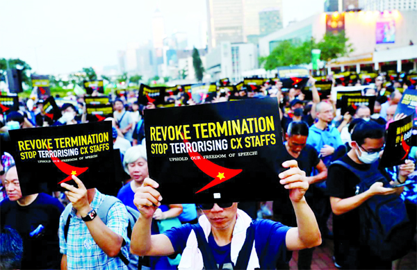 People take part in a rally held by the Hong Kong Confederation of Trade Unions after a number of crew members in the aviation industry were let go for joining the anti-extradition bill protests, in Hong Kong, China on Wednesday.