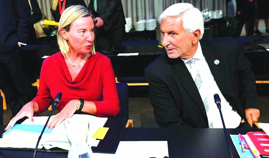 EU foreign policy chief Federica Mogherini and General Director for Foreign Affairs of the Council of the European Union Leonardo Schiavo chat before the informal meeting of EU defence ministers in Helsinki, Finland on Wednesday.