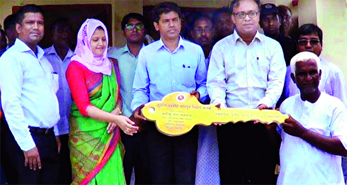 SAKHIPUR (Tangail): Md Shahidul Islam, DC, Tangail distributing keys of houses among the landless people at Sakhipur organised by Disaster Tolerance House Building Project of Disaster Management and Relief Ministry as Chief Guest on Tuesday.