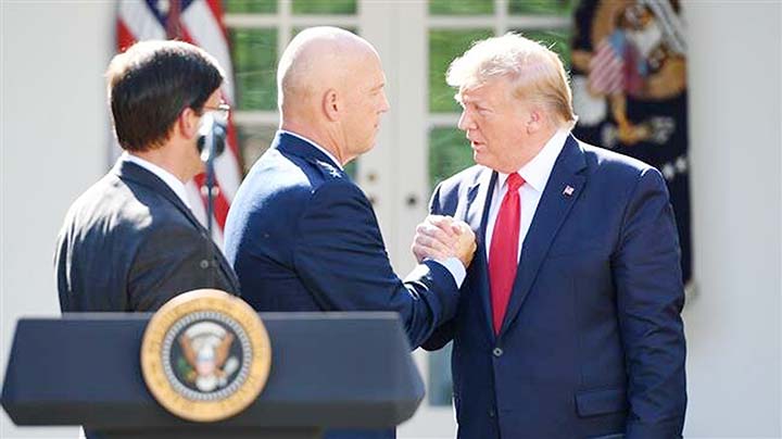 US President Donald Trump Â® shakes hands with US General John W. Raymond during an event establishing the US Space Command in the Rose Garden of the White House in Washington, DC on Thursday.