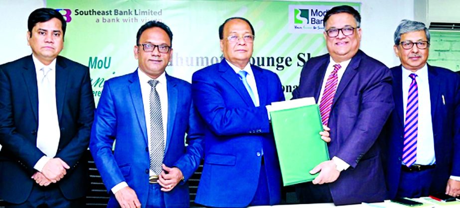Md. Shafiul Azam, Managing Director of Modhumoti Bank Limited (MBL) and M Kamal Hossain, Managing Director of Southeast Bank Limited (SBL), exchanging an agreement signing document to established "Modhumoti Lounge" at the international terminal of Shah