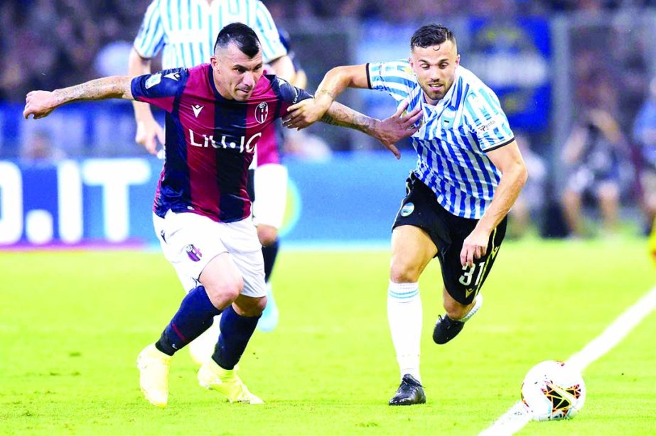 Bologna's Gary Medel (left) vies for the ball with Spal's Federico Di Francesco, during the Serie A soccer match between Bologna and Spal at the Dall'Ara stadium in Bologna, Italy on Friday.