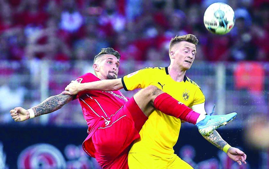 Berlin's Robert Andrich (left) and Marco Reus of Borussia Dortmund battle for the ball during a German Bundesliga soccer match between FC Union Berlin and Borussia Dortmund in Berlin, Germany on Saturday.