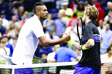 Nick Kyrgios (left) of Australia, shakes hands with Andrey Rublev of Russia, after Rublev won their match during the third round of the U.S. Open tennis tournament in New York on Saturday.