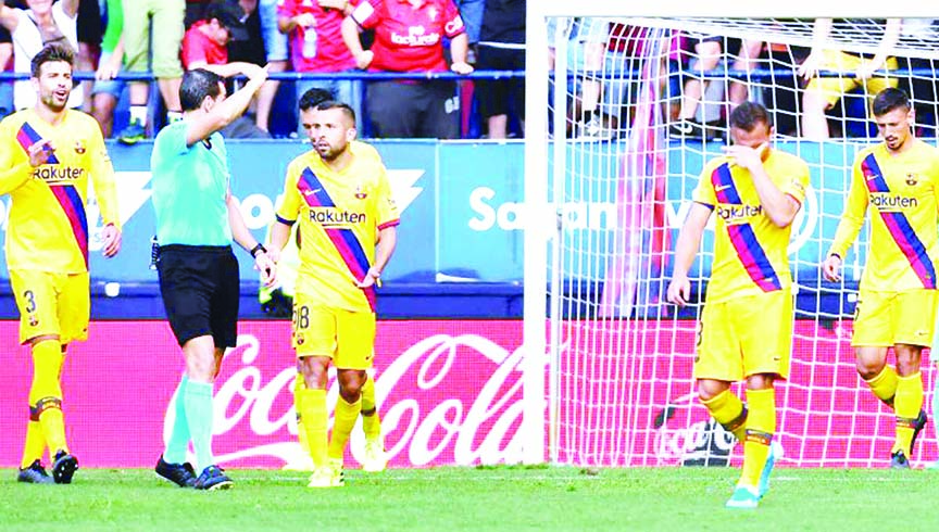 FC Barcelona players in dejection after Osasuna's Roberto Torres scored his side second goal during the Spanish La Liga soccer match between FC Barcelona and Osasuna, at El Sadar stadium in Pamplona, northern Spain on Saturday.