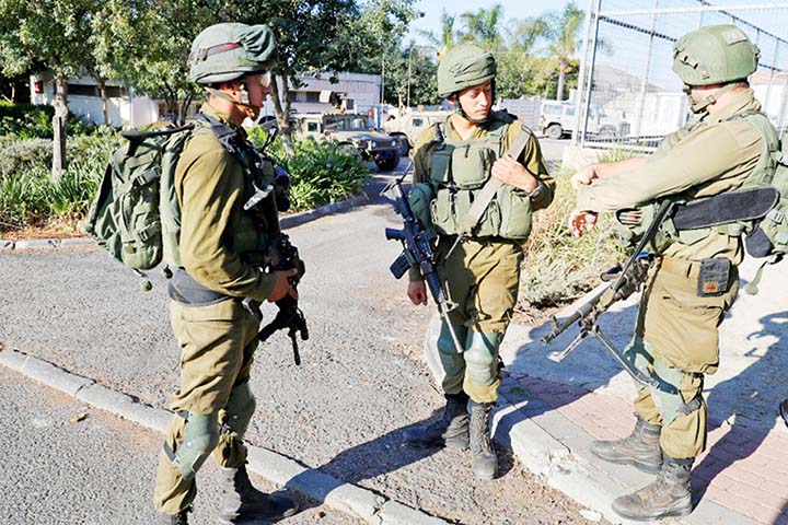 Israeli soldiers stand guard in the northern town of Avivim, close to the border with Lebanon.