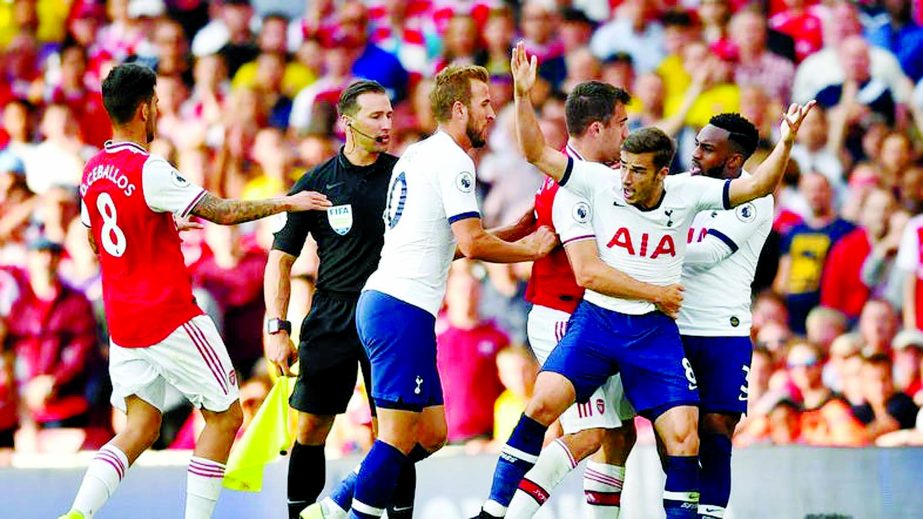 Players clash during the English Premier League football match between Arsenal and Tottenham Hotspur at the Emirates Stadium in London on Sunday.