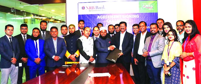 Md. Mehmood Husain, CEO of NRB Bank Limited and Ikram Farazy, CEO of NEC Money Transfer Limited, exchanging an agreement signing document at the banks head office in the city recently. Under the deal, the bank will disburse foreign remittance collected by