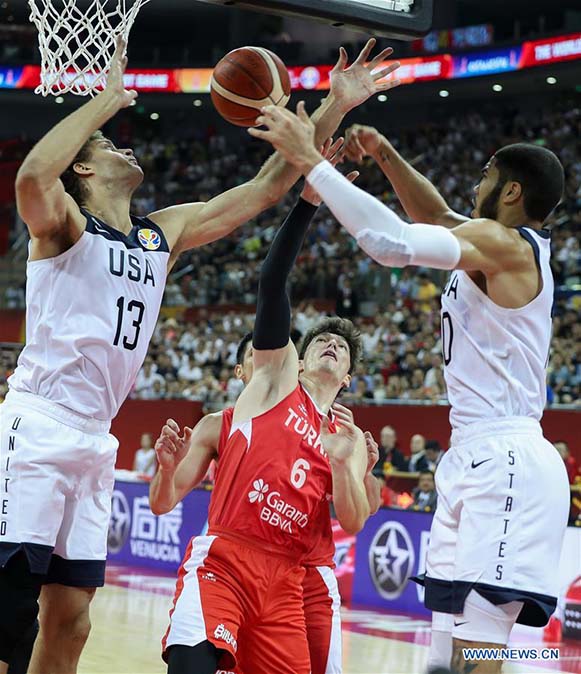 Brook Lopez (left) and Jayson Tatum (right) of the United States fight for a rebound with Cedi Osman of Turkey during the group E match between the United States and Turkey at the 2019 FIBA World Cup in Shanghai, east China on Tuesday.
