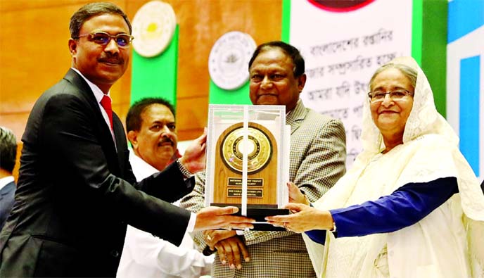 Prime Minister Sheikh Hasina handing over National Export Trophy (Silver) for the Year 2016-2017 to Pervez Rahman, Managing Director of BRB Cable Industries Ltd at Bangabandhu International Conference Center (BICC) in the city recently in recognition of i