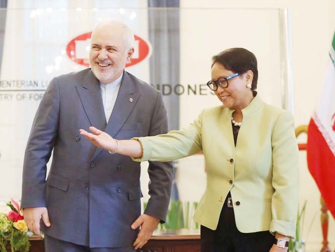 Iran's Foreign Minister Mohammad Javad Zarif, (left) is greeted by his Indonesian counterpart Retno Marsudi prior to their meeting in Jakarta, Indonesia on Friday.