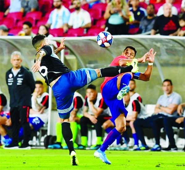 Leandro Paredes of Argentina (L) vies for the ball with Alexis Sanchez of Chile (R) as the teams played to a 0-0 draw in their friendly international football match at LA Memorial Coliseum on Thursday.
