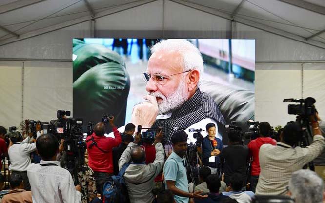 India's Prime Minister Narendra Modi is seen on a TV screen as he watches the live broadcast of the attempted moon landing of spacecraft Vikram Lander of Chandrayaan-2.