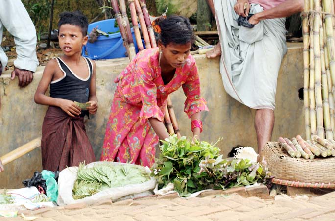 Rohingya Children selling vegetables at Balukhali Rohingya Camp in Ukhiya on Friday.
