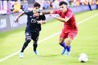 U.S. midfielder Alfredo Morales (15) fends off Mexico midfielder Uriel Antuna (26) during the second half of an international friendly soccer match in East Rutherford, N.J on Friday. Mexico won 3-0.