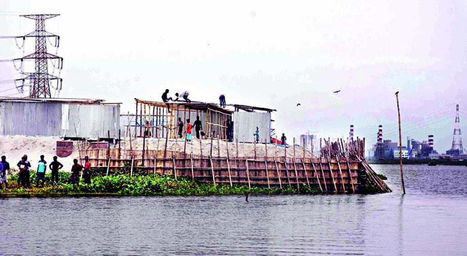 Some vested groups started regrabbing the Meghna River bank areas before the eviction could be successfully carried out for saving the river. This photo was taken from Sonargaon point on Saturday.