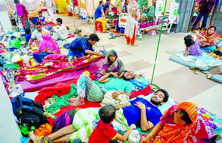 Patients suffering from dengue fever rest on the floor of a ward at the Khulna Medical College Hospital as the hospital run out of beds amid a growing number of dengue cases in the district. This photo was taken on Sunday.