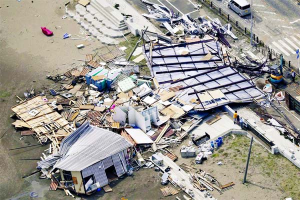 Beach houses are damaged as typhoon hits the beacfront area in Miura, south of Tokyo on Monday.