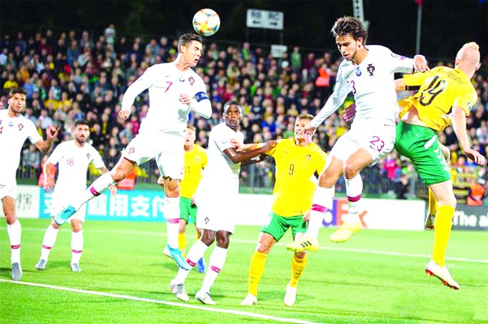 Cristiano Ronaldo (left) of Portugal competes during the UEFA EURO 2020 qualifying round Group B soccer match between Lithuania and Portugal in Vilnius, Lithuania on Tuesday.